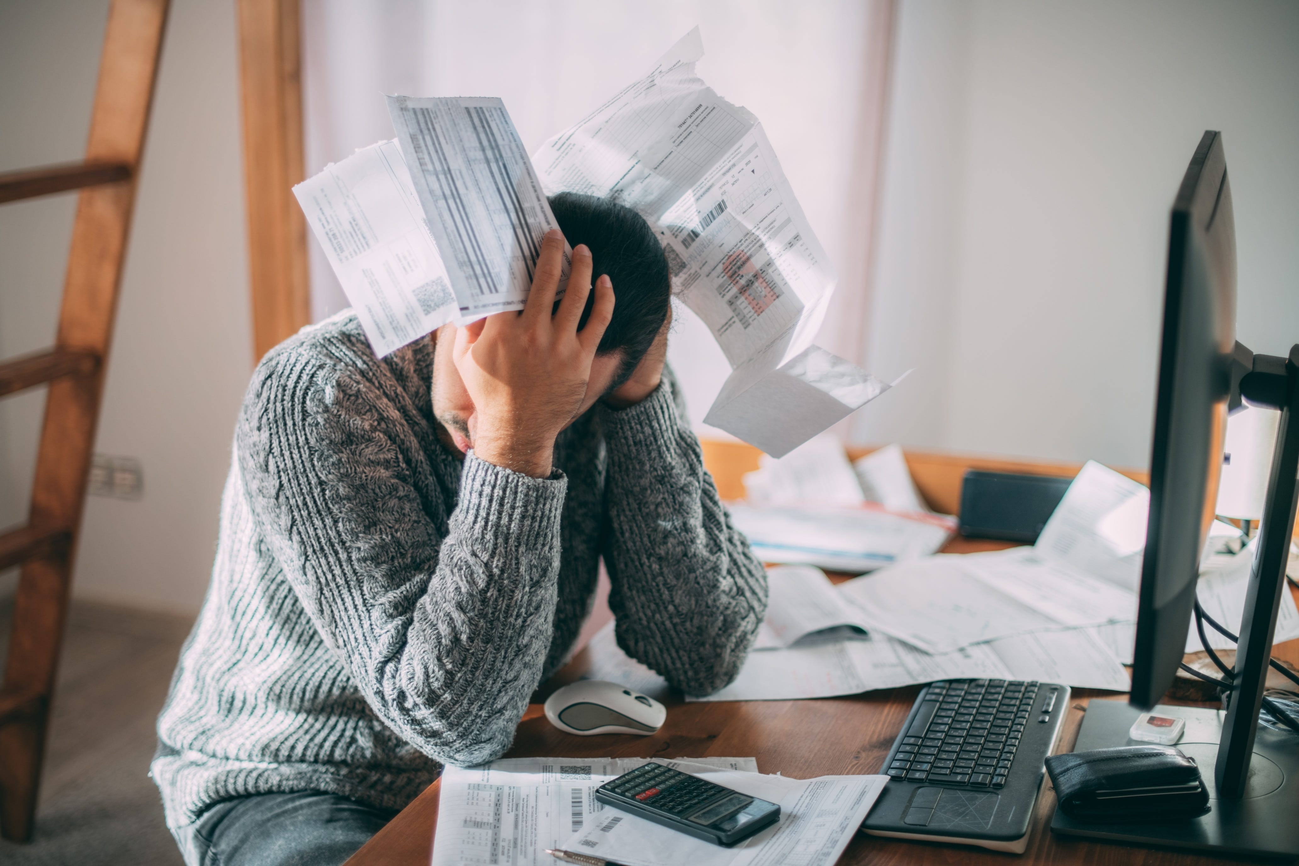 Frustrated man looking at bills